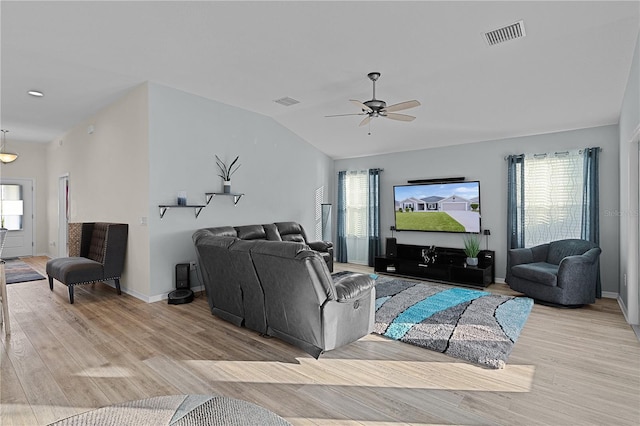 living room featuring light hardwood / wood-style floors, vaulted ceiling, and ceiling fan