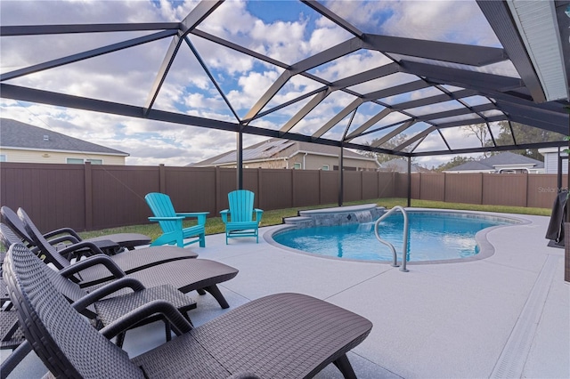 view of pool featuring glass enclosure, a patio area, and pool water feature