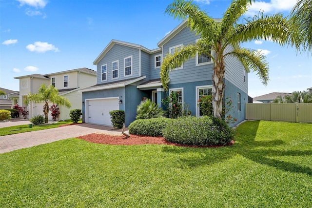 view of front of home featuring a front yard and a garage