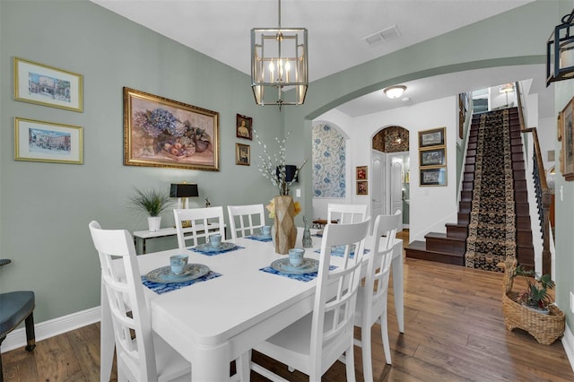 dining space featuring a chandelier and dark hardwood / wood-style floors