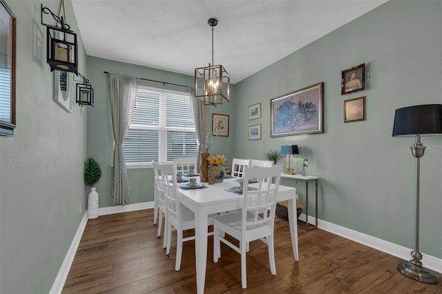 dining area featuring a notable chandelier and dark hardwood / wood-style floors