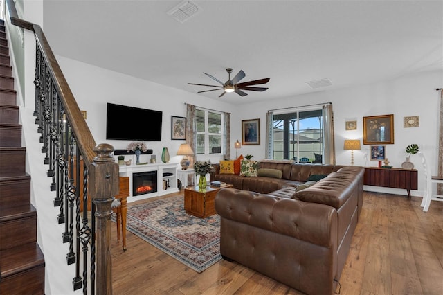 living room with hardwood / wood-style flooring and ceiling fan