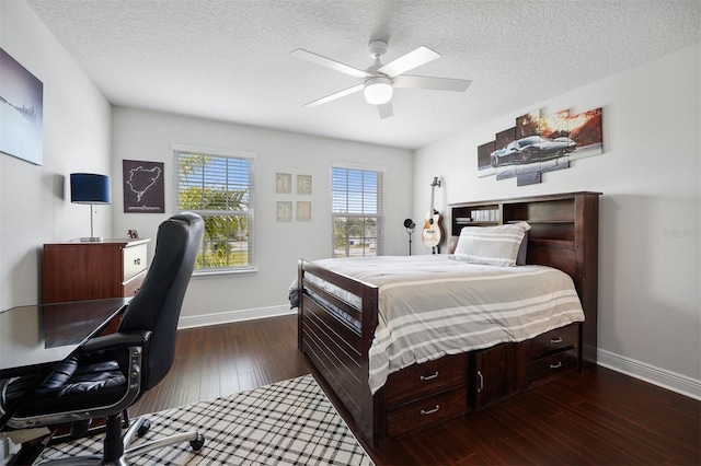 bedroom with ceiling fan, dark wood-type flooring, and a textured ceiling