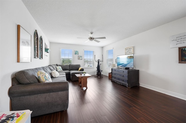 living room featuring a textured ceiling, ceiling fan, and dark hardwood / wood-style floors