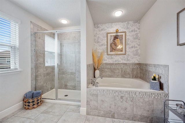 bathroom with a textured ceiling, plus walk in shower, and a healthy amount of sunlight