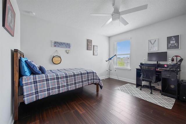 bedroom with ceiling fan, hardwood / wood-style floors, and a textured ceiling