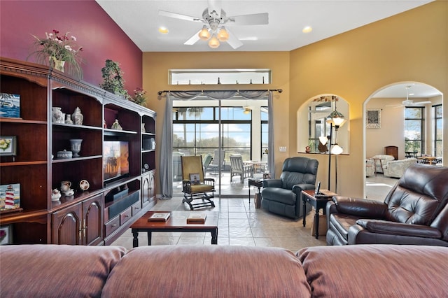 living room featuring light tile patterned floors, plenty of natural light, and ceiling fan