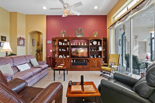 tiled living room with ceiling fan