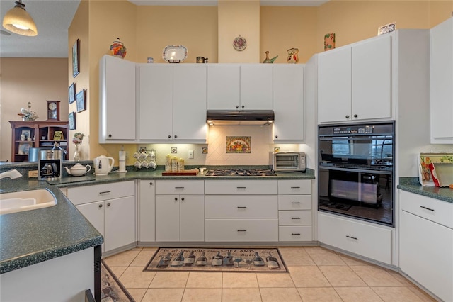 kitchen featuring white cabinetry, sink, stainless steel gas cooktop, black double oven, and light tile patterned floors