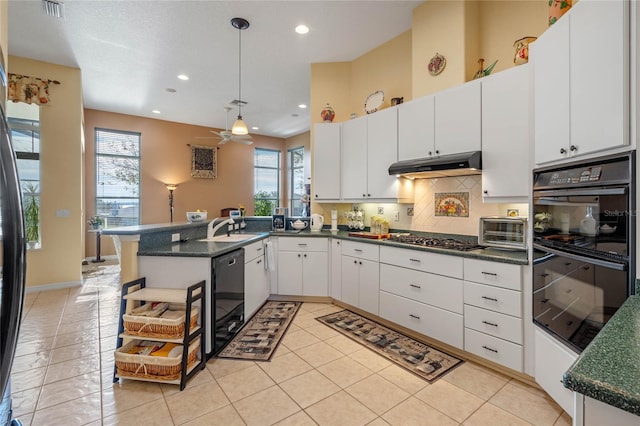 kitchen featuring black appliances, white cabinetry, kitchen peninsula, and pendant lighting