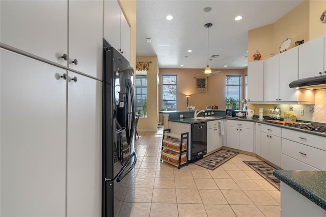 kitchen with black appliances, ceiling fan, white cabinetry, and kitchen peninsula