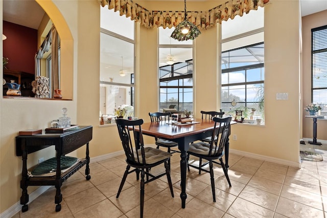 tiled dining area featuring ceiling fan