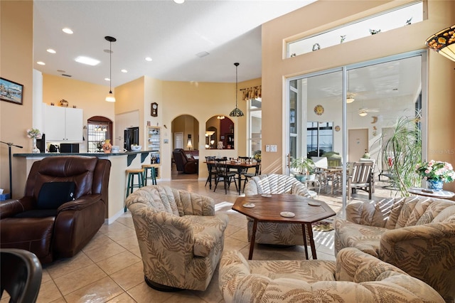 living room featuring light tile patterned floors and a high ceiling