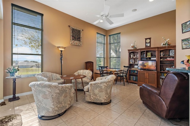 living room featuring light tile patterned floors, a wealth of natural light, and ceiling fan