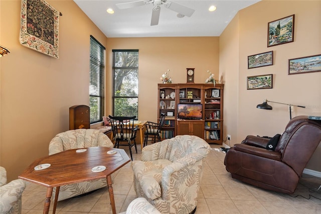 living area featuring ceiling fan and light tile patterned flooring