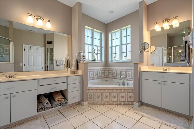 bathroom featuring tile patterned flooring, vanity, and separate shower and tub