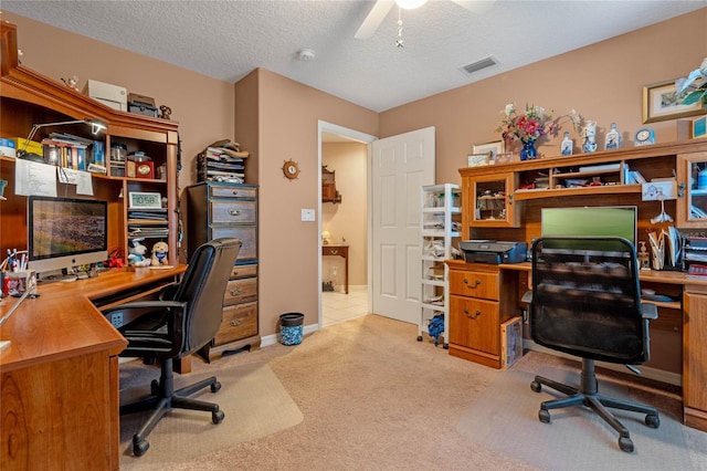 office with ceiling fan, a textured ceiling, and light carpet