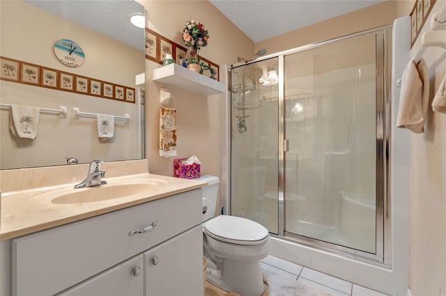 bathroom with walk in shower, tile patterned floors, a textured ceiling, toilet, and vanity