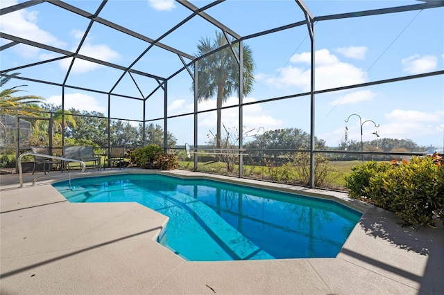 view of swimming pool with a patio and glass enclosure