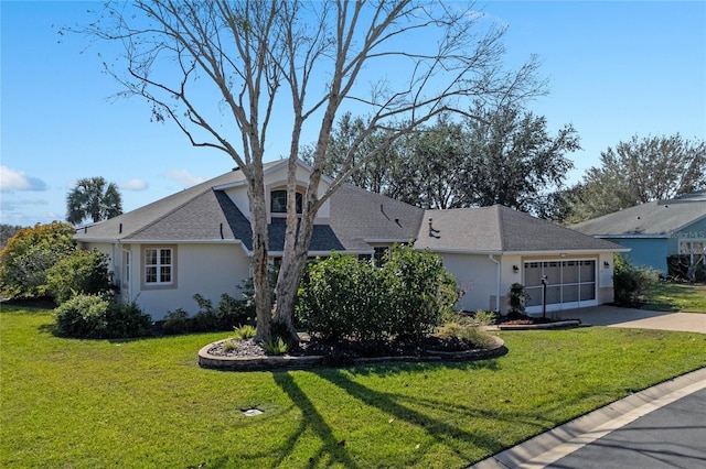 view of front of house featuring a garage and a front lawn