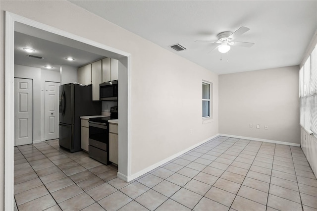 kitchen with white cabinets, light tile patterned flooring, ceiling fan, and black appliances