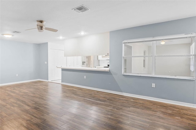 unfurnished living room featuring hardwood / wood-style flooring and ceiling fan