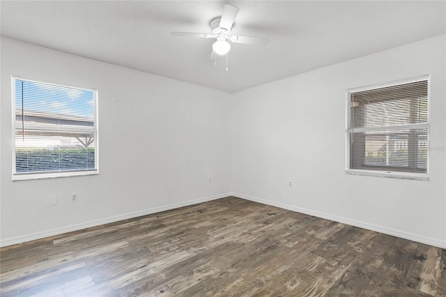 empty room featuring ceiling fan and dark wood-type flooring