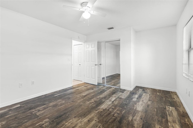 unfurnished bedroom with dark hardwood / wood-style flooring and ceiling fan