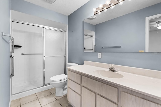 bathroom with tile patterned floors, vanity, a textured ceiling, and walk in shower