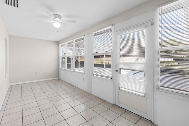 unfurnished sunroom with ceiling fan and a wealth of natural light