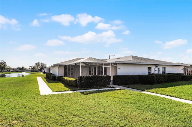 ranch-style house with glass enclosure, a water view, and a front yard