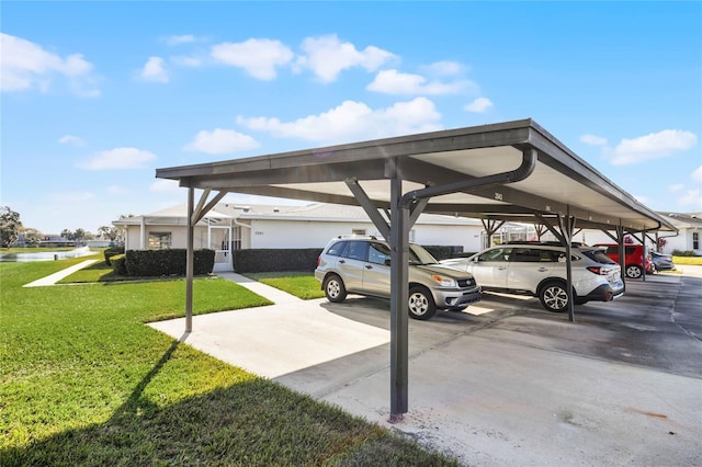 view of parking / parking lot featuring a yard and a carport