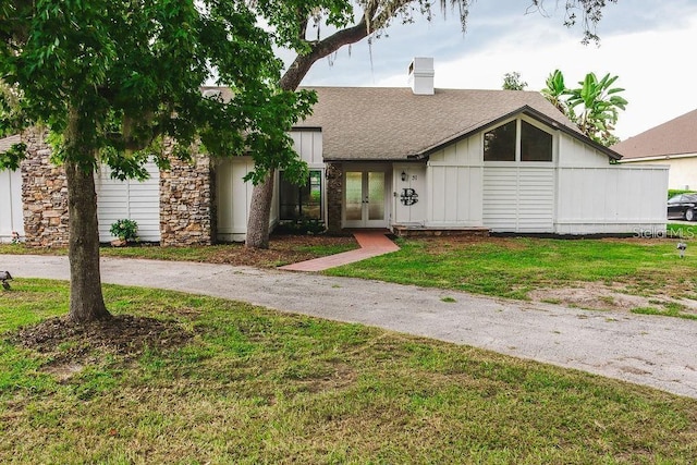 view of front of house featuring french doors and a front lawn