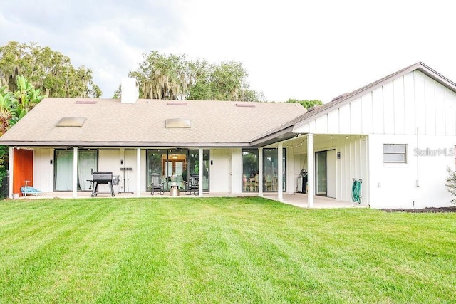 back of property featuring a patio area and a yard