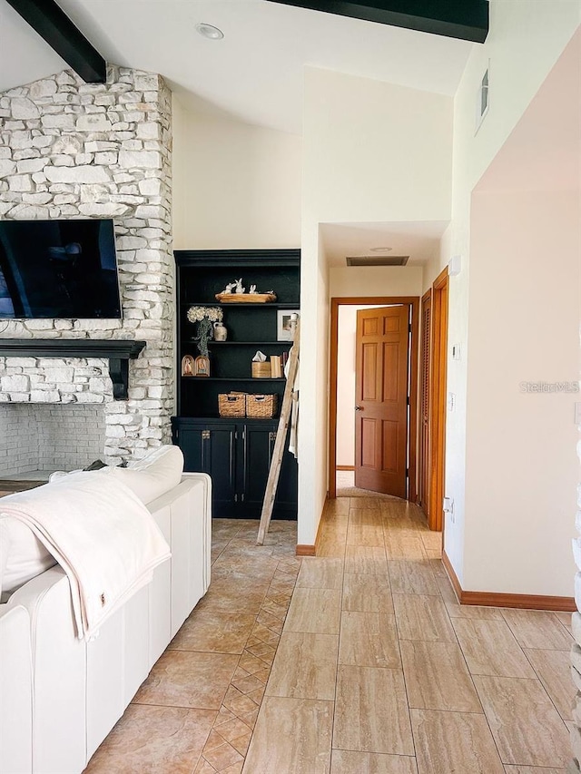 interior space featuring lofted ceiling with beams