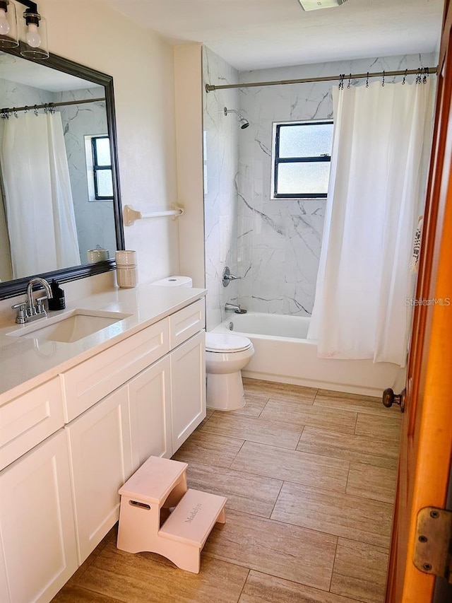 full bathroom with vanity, shower / bathtub combination with curtain, and toilet