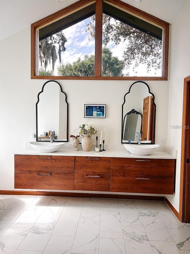 bathroom with vanity and lofted ceiling