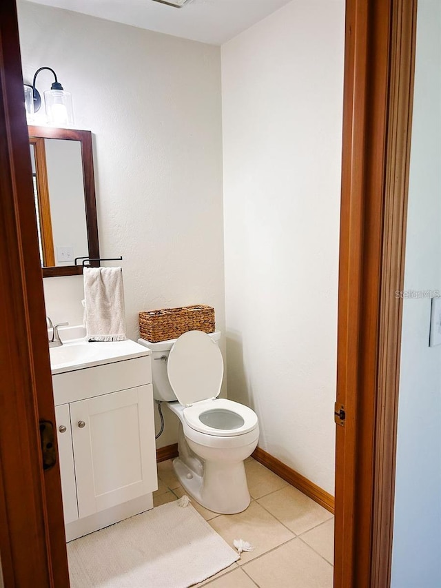 bathroom featuring tile patterned floors, vanity, and toilet