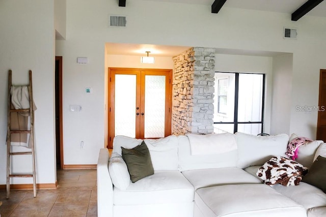 tiled living room with french doors and beam ceiling