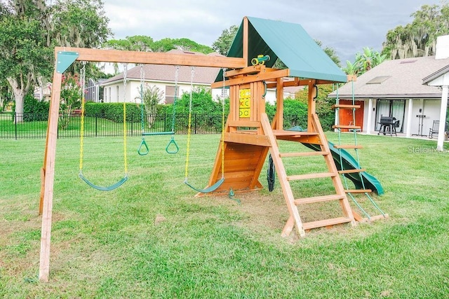 view of jungle gym featuring a lawn