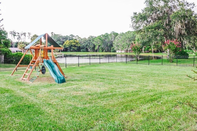 view of jungle gym featuring a yard and a water view