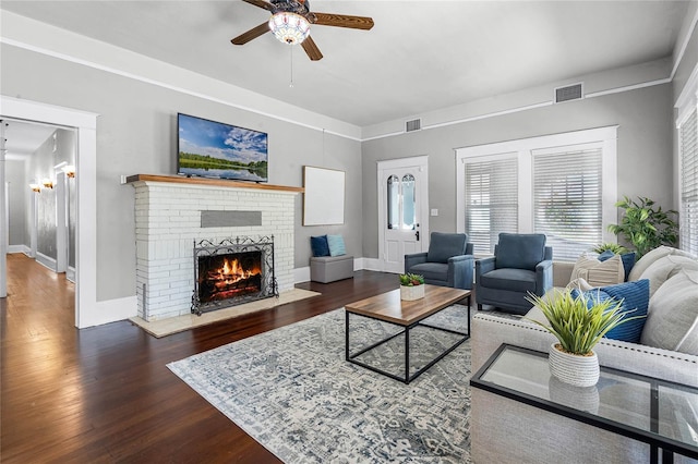 living room with ceiling fan, dark hardwood / wood-style flooring, and a fireplace