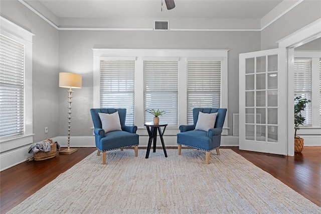 living area featuring ceiling fan and dark hardwood / wood-style floors