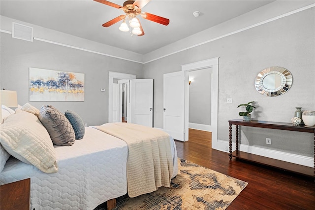 bedroom with ceiling fan and dark hardwood / wood-style floors