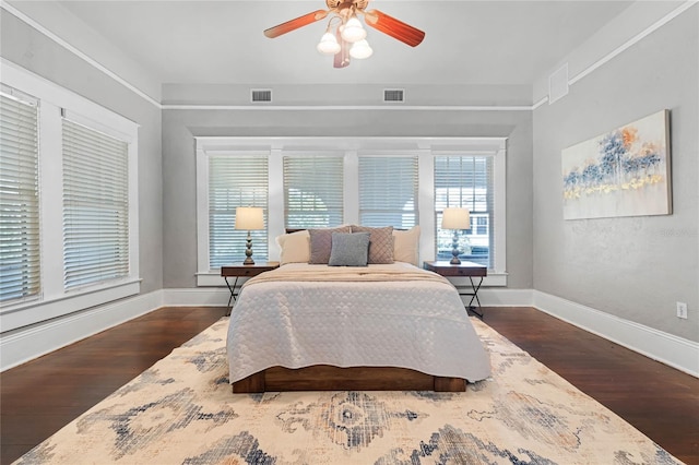 bedroom with ceiling fan and dark wood-type flooring