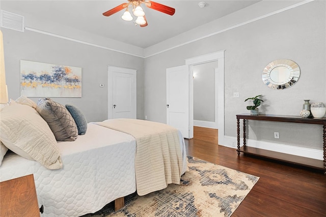 bedroom featuring dark hardwood / wood-style floors and ceiling fan