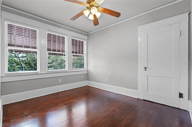 unfurnished room with crown molding, ceiling fan, and dark wood-type flooring