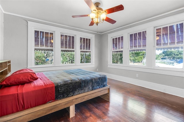 bedroom featuring ceiling fan, dark hardwood / wood-style floors, and ornamental molding