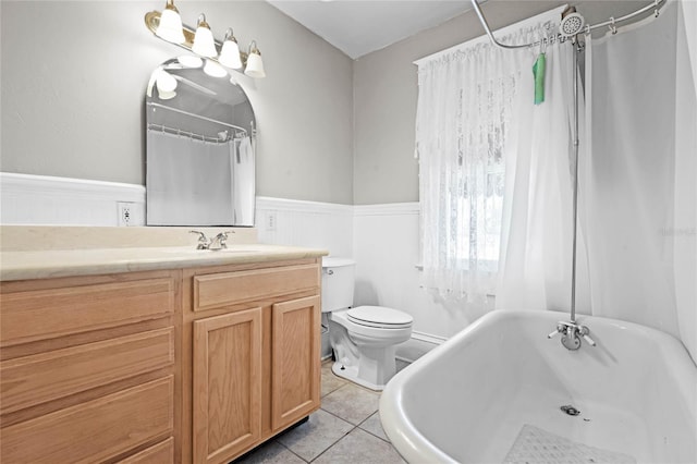 bathroom with tile patterned flooring, vanity, and toilet