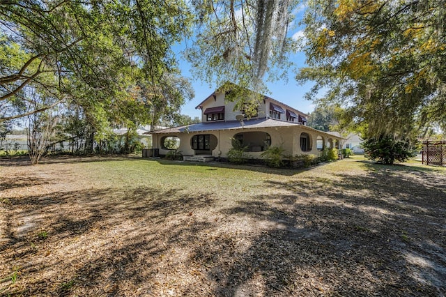 view of property exterior with a yard and central AC unit